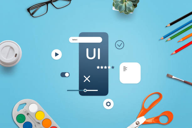 میز کار طراح UI/UX شامل وایرفریم اپلیکیشن موبایل و پالت رنگی