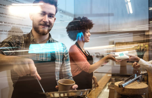 صاحب یک کافیشاپ کوچک در حال استفاده از فناوری هوش مصنوعی برای افزایش سفارشات و مدیریت کسبوکار