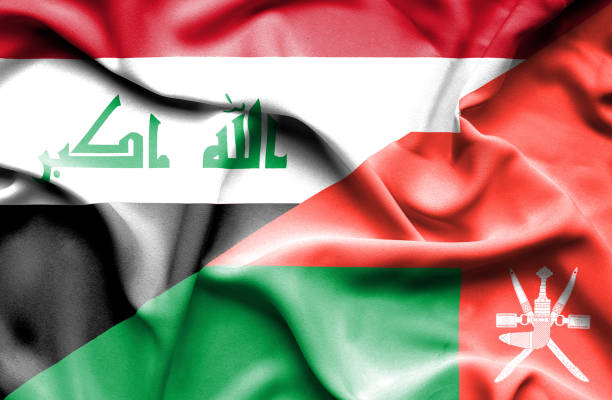 پرچمهای در حال اهتزاز عراق و عمان در کنار یکدیگر - نمادی از جذب توریست سلامت از عراق و عمان برای کلینیکهای کاشت مو در مشهد