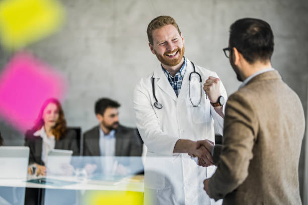 برندینگ دیجیتال پزشکی و سئو آزمایشگاه تشخیص طبی: پزشک و مدیر در حال عقد قرارداد دیجیتال مارکتینگ سلامت