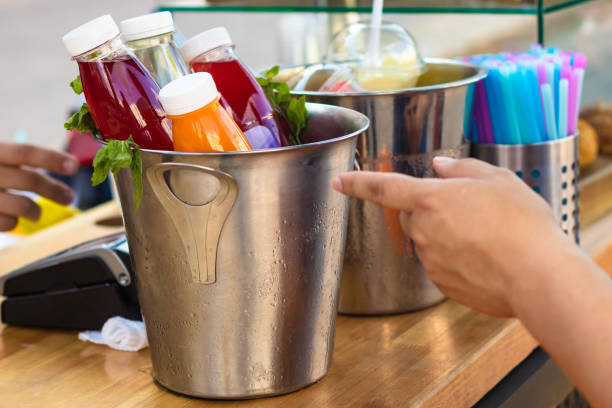 عمدهفروشی نوشیدنیها - انتخاب نوشیدنی خنک از قفسه، نمادی از خرید مستقیم از فروشنده در فروشیاب