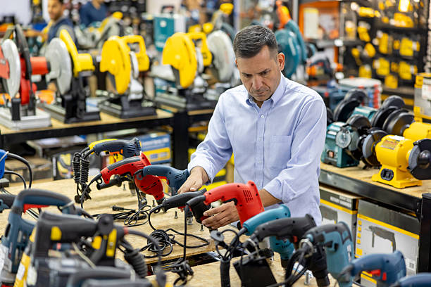 فروش یاب: مردی در حال خرید دریل در یک فروشگاه ابزار. فرصت‌های خرید و فروش عمده و آگهی تجاری